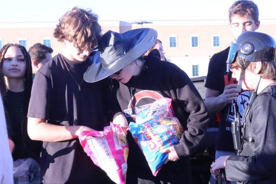 Students share and distribute candy to the community during Trunk or Treat. Photo Credit: LTHS Yearbook